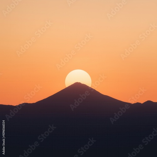 Minimalistic landscape with the sun rising behind a mountain, casting warm orange hues across the sky.