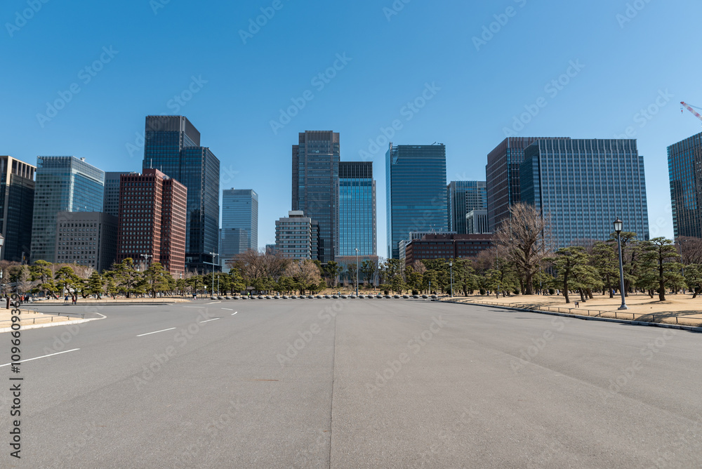 Tokyo Cityscape in Background and Park in Foreground with Road and Skyscrapers with Clear Blue Sky. Japan. Close to Inperial Palace Tokyo Cityscape in Background and Park in Foreground with Road and Skyscrapers with Clear Blue Sky. Japan. Close to Inperial Palace