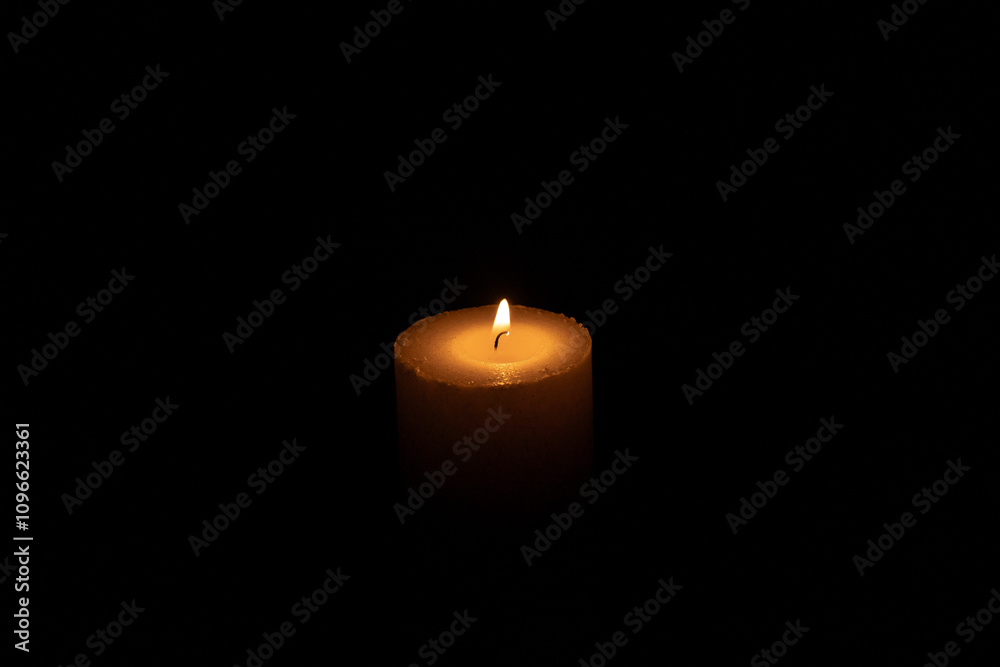 Close-up of a candle's flame glowing warmly, with wax dripping in silence over a dark, empty backdrop. Close-up of a candle's flame glowing warmly, with wax dripping in silence over a dark, empty backdrop.