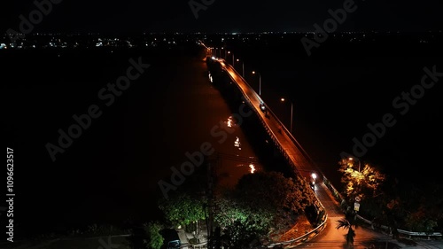 Motorbike Traffic on a Bridge over the Thu Bon River at Night in Hoi An, Vietnam