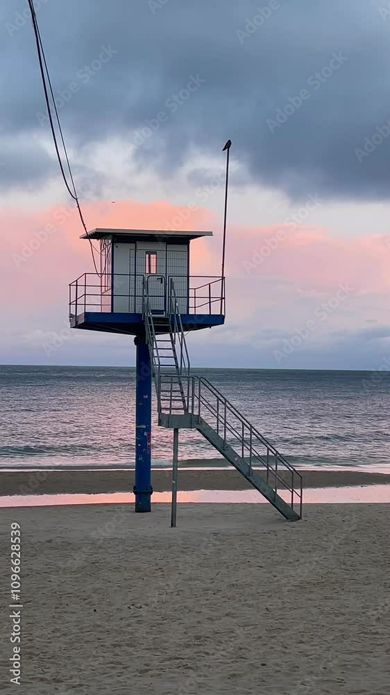 lifeguard tower on the beach in sunset light with waves on the sea lifeguard tower on the beach in sunset light with waves on the sea