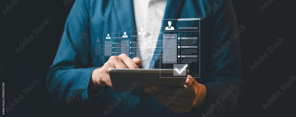 A businessman using a tablet with digital resume icons and a checkmark, symbolizing recruitment, digital hiring processes, and professional evaluation.