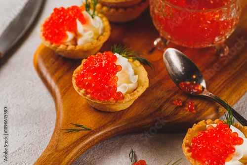 Tartlets with red caviar and cottage cheese photo