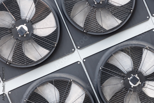 Four fans are mounted on a wall