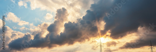 Dramatic clouds part to reveal striking sun rays cutting through, creating a powerful and awe-inspiring scene of nature's beauty and contrasting light over a vast sky. photo