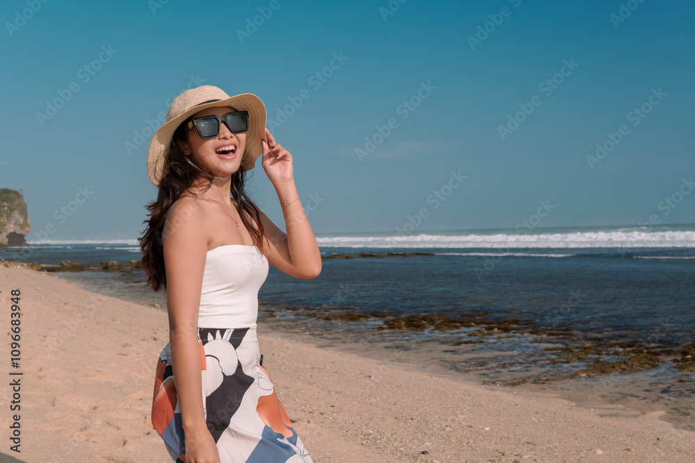Beautiful Asian woman standing by the Drini beach, Yogyakarta, enjoying holiday and traveling. Beautiful Asian woman standing by the Drini beach, Yogyakarta, enjoying holiday and traveling.
