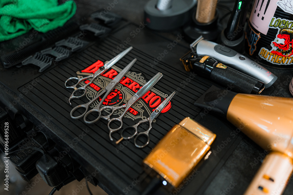 A neatly organized barbershop workstation with scissors, clippers, a razor, and a hairdryer. Perfect for themes of grooming, professional barbering, and stylish men's hairstyling equipment. A neatly organized barbershop workstation with scissors, clippers, a razor, and a hairdryer. Perfect for themes of grooming, professional barbering, and stylish men's hairstyling equipment.