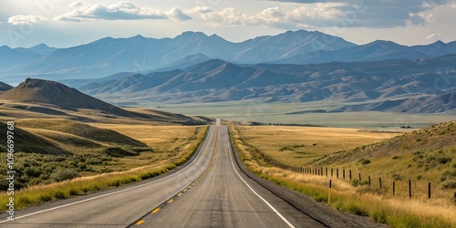 Rolling hills and mountains in the distance along a long empty highway asphalt road, landscape, outdoors, asphalt, rural, hills