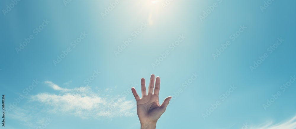Hippie hand raised in salute against bright blue sky symbolizing freedom and positivity in a serene outdoor setting Hippie hand raised in salute against bright blue sky symbolizing freedom and positivity in a serene outdoor setting