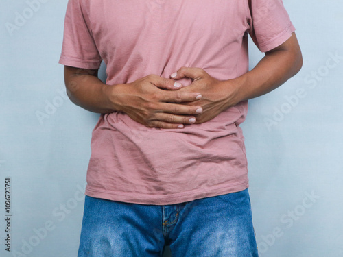 Young man suffering from an abdominal pain, healthcare concept white background