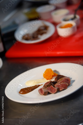 Ready to be eat, plate of cooked meat with sauces in side