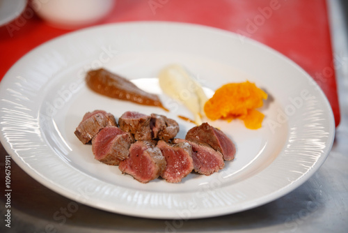 Ready to be eat, plate of cooked meat with sauces in side