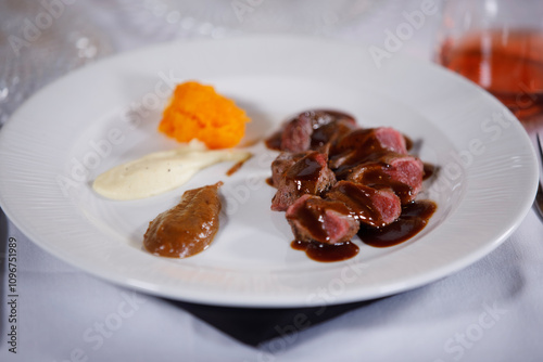 Ready to be eat, plate of cooked meat with sauces in side