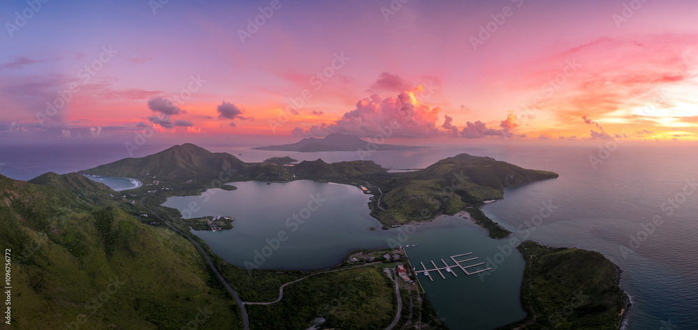 Christophe Harbor on St. Kitts and Nevis in the Caribbean with palm trees and stunning colorful sunset with pink, purple light painting the clouds