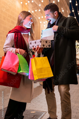 Couple surprised opening gift box festive city night Christmas holiday season photo