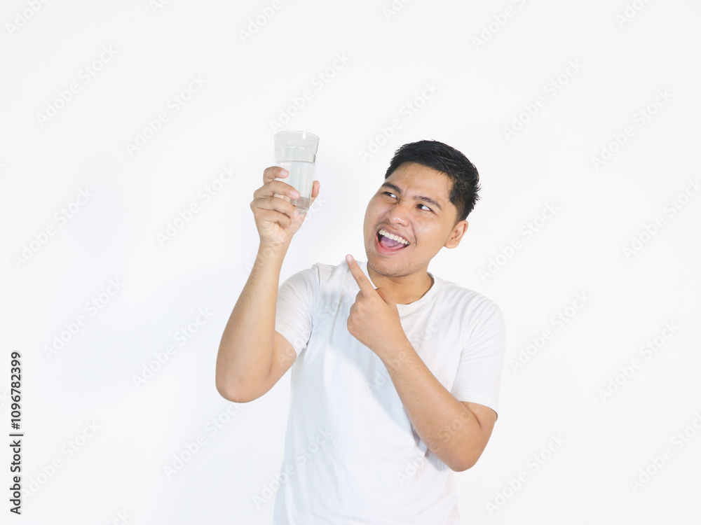 Adult Asian man looking to the glass of water that he hold