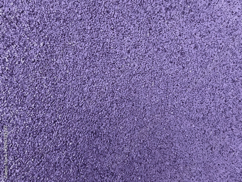 Flexible lilac tile for playground. Lilac violet soyut rubber coating for children playground. Texture granular background. Outdoor floor covering for sports fitness games, soft rubber granules.
