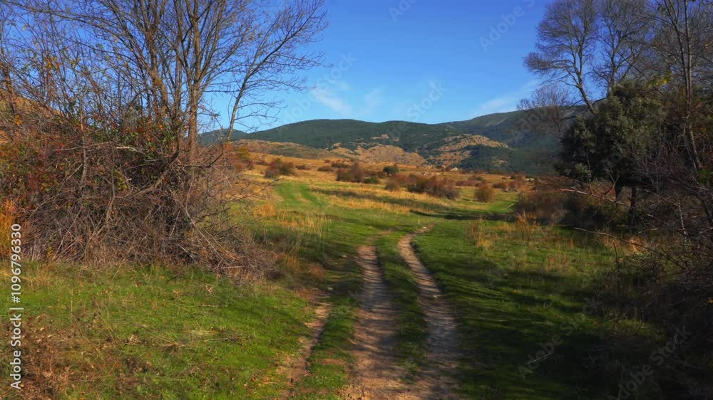 Scenic Autumn Dirt Path in Spanish Countryside with Mountains Scenic Autumn Dirt Path in Spanish Countryside with Mountains
