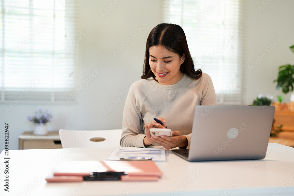 Asian Businesswoman Using laptop computer and working at office with calculator document on desk, doing planning analyzing the financial report, business plan investment, finance analysis concept. Asian Businesswoman Using laptop computer and working at office with calculator document on desk, doing planning analyzing the financial report, business plan investment, finance analysis concept.