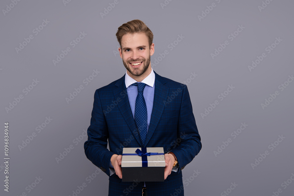 Businessman prepare for romance date. Business reward. Business man with corporate gift box isolated on grey. Corporate present. Mens day. Successful boss share gift box. Client appreciation token Businessman prepare for romance date. Business reward. Business man with corporate gift box isolated on grey. Corporate present. Mens day. Successful boss share gift box. Client appreciation token
