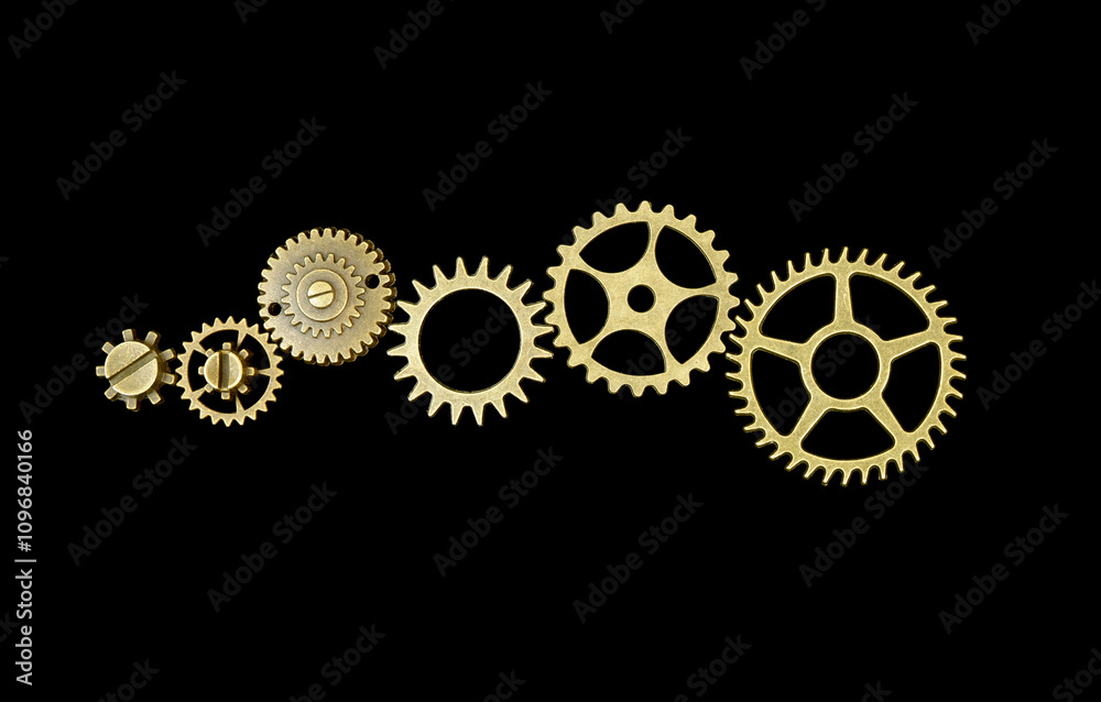 Six metallic gears wheels connected in one mechanism isolated on black background. Six metallic gears wheels connected in one mechanism isolated on black background.
