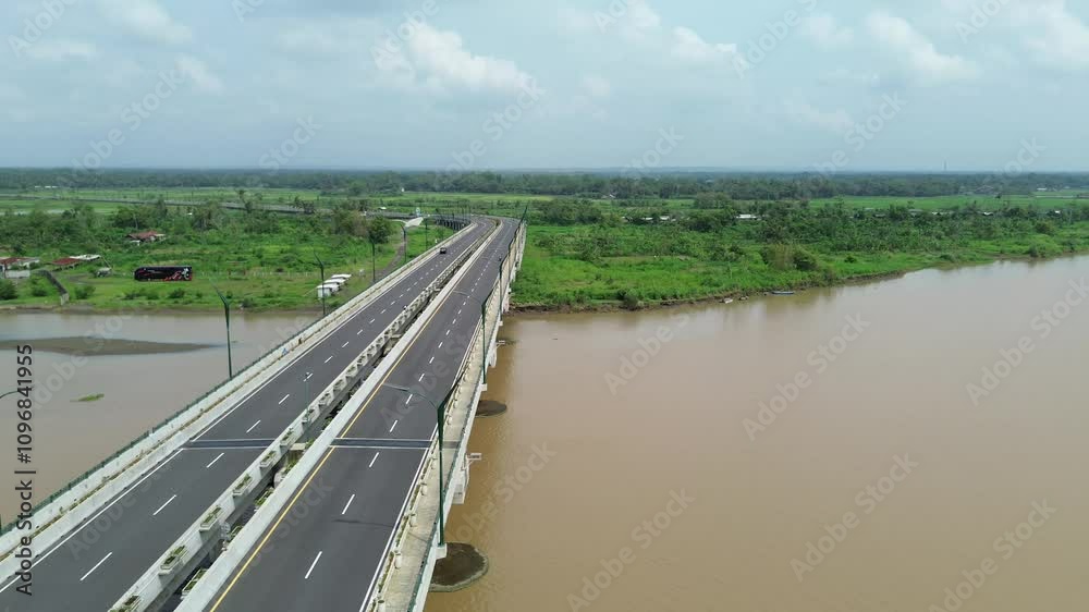 Aerial view of a long bridge stretching over a wide river. Aerial view of a long bridge stretching over a wide river.