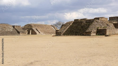 Ancient Mayan Plaza and Temple Ruins Under Cloudy Mexican Sky at Monte Alban