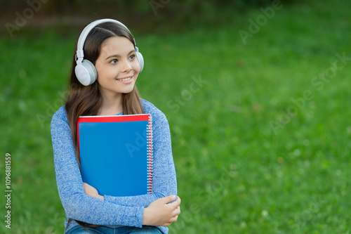 Teen girl in headphones. Student listen audiobook. Homework education. Back to school. Student teen girl listen audiobook. School education for girl. Student lifestyle. School education. Copy space