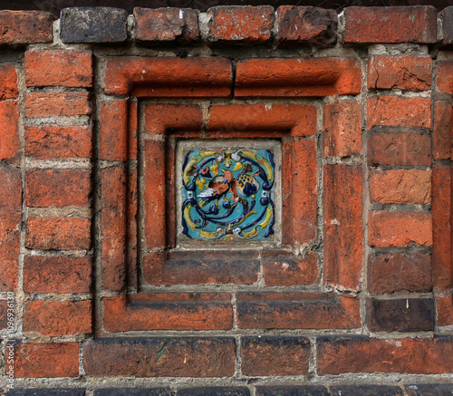 Old decorative glazed ceramic picture ceramic ornament.