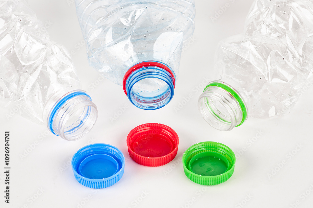 Plastic water bottle isolated on white background. Used twist water plastic bottles with colored caps. Plastic water bottle isolated on white background. Used twist water plastic bottles with colored caps.