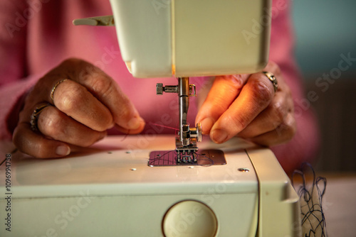 A hobbyist using an electric  sewing machine