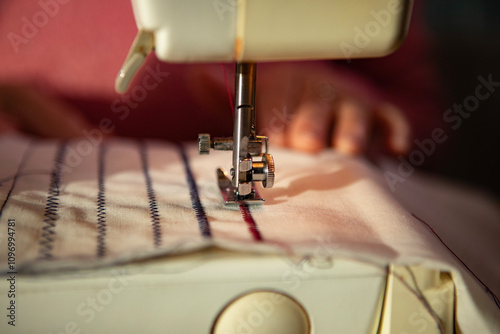 A hobbyist using an electric  sewing machine