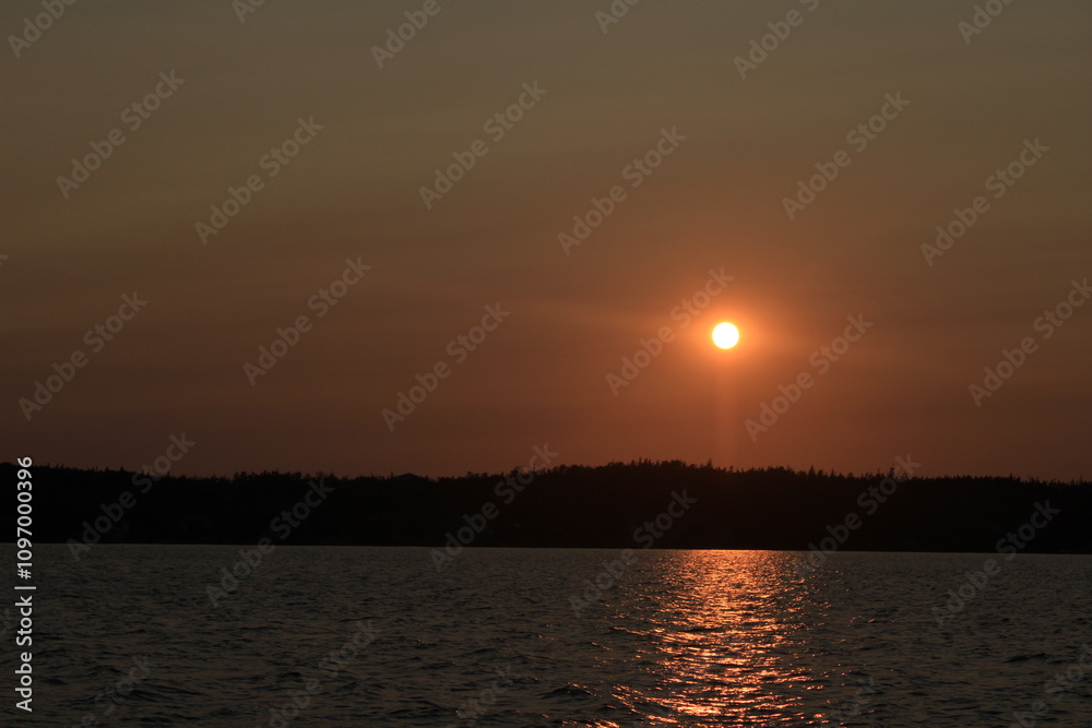 Sunset Over Water with Silhouetted Trees Sunset Over Water with Silhouetted Trees