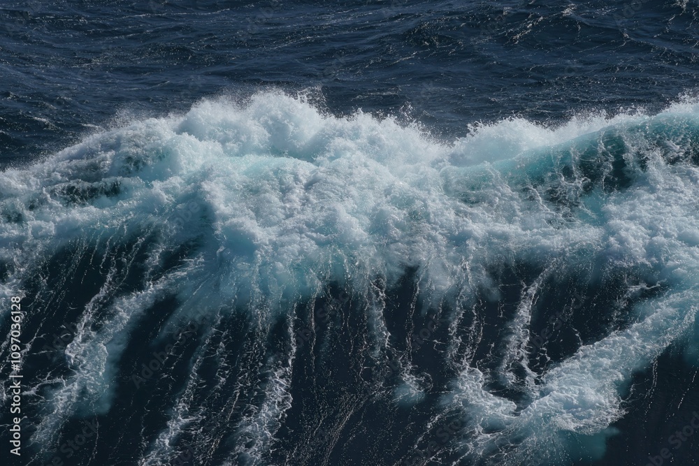 Majestic ocean waves crashing with frothy white foam against deep blue sea, creating dynamic and powerful natural scene Majestic ocean waves crashing with frothy white foam against deep blue sea, creating dynamic and powerful natural scene