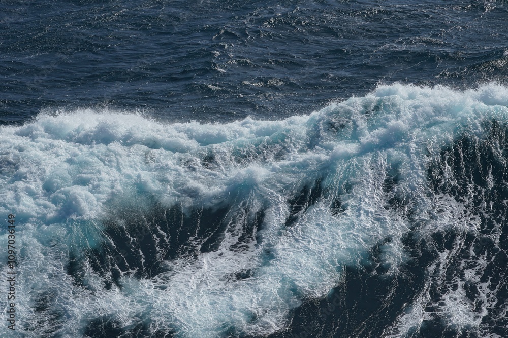 Majestic ocean waves crashing against each other, creating dynamic and powerful scene. deep blue water contrasts beautifully with frothy white foam, evoking sense of tranquility and strength Majestic ocean waves crashing against each other, creating dynamic and powerful scene. deep blue water contrasts beautifully with frothy white foam, evoking sense of tranquility and strength