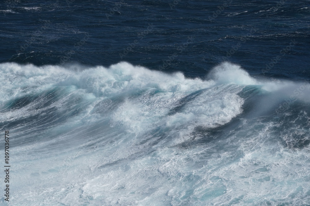 Majestic ocean waves crashing against shore, creating dynamic and powerful scene. deep blue water contrasts beautifully with white foam, evoking sense of tranquility and strength Majestic ocean waves crashing against shore, creating dynamic and powerful scene. deep blue water contrasts beautifully with white foam, evoking sense of tranquility and strength