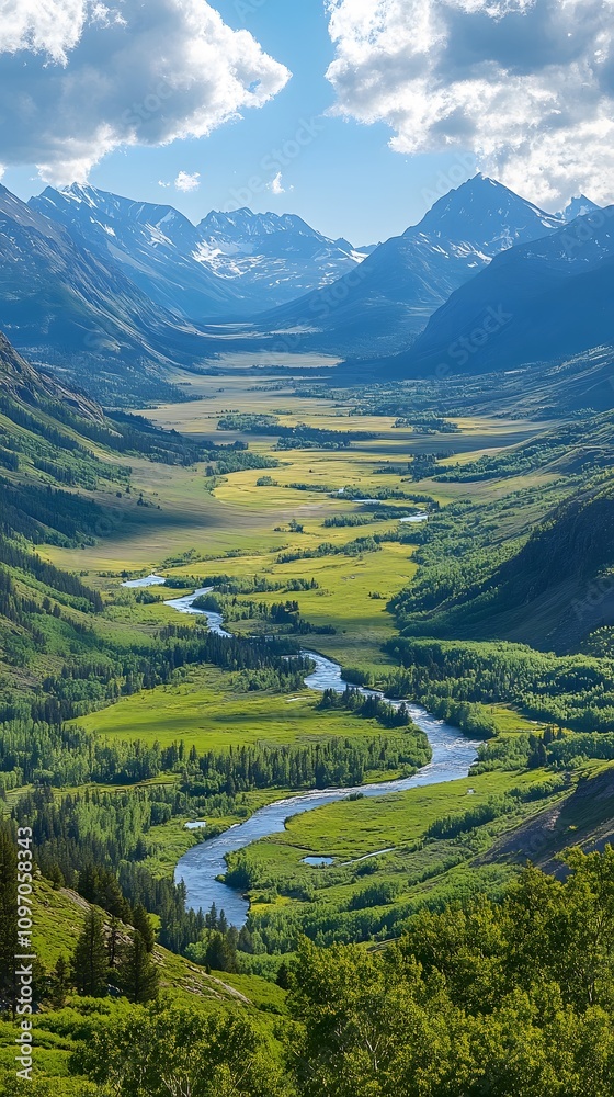 Fototapeta premium Breathtaking mountain valley landscape with a winding river under a bright blue sky.