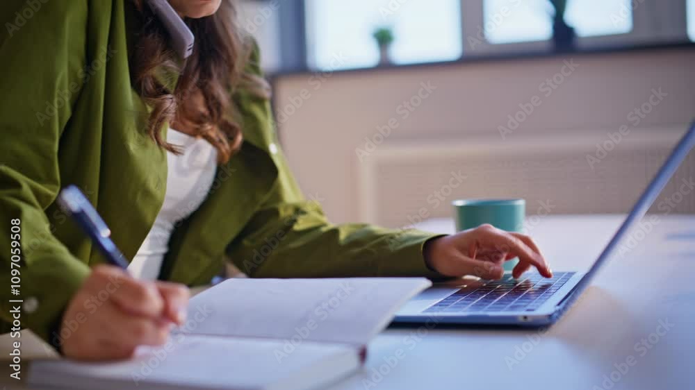 Calling woman writing notes in notebook at office closeup. Busy businesswoman Calling woman writing notes in notebook at office closeup. Busy businesswoman
