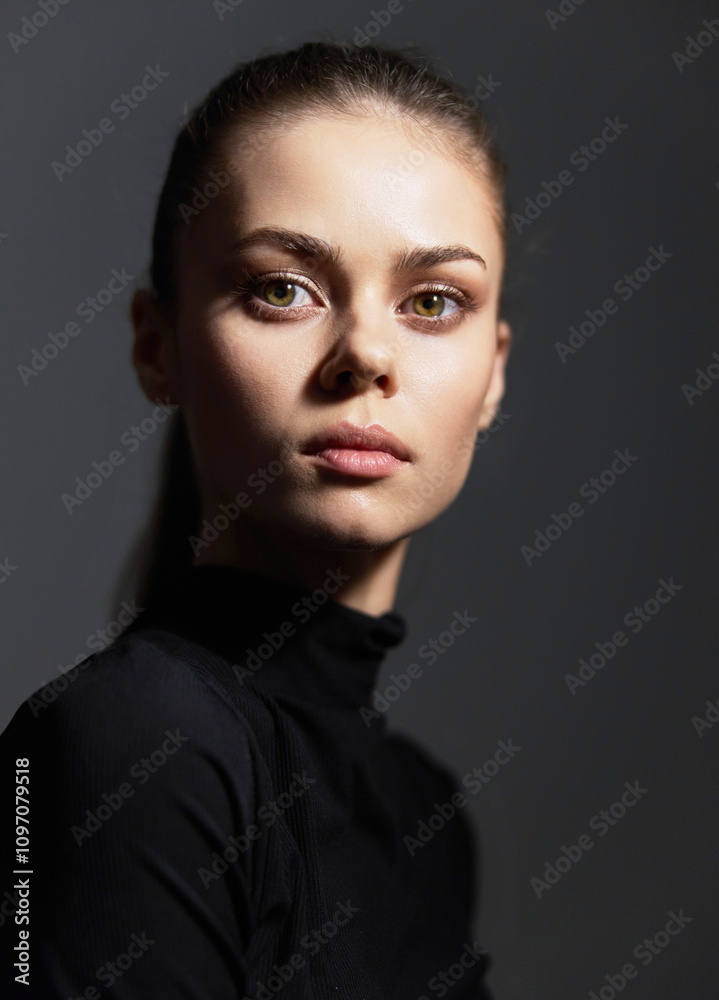 Thoughtful young woman in black turtleneck, gazing at the camera with an intense expression. Minimalist background enhancing her features. Portrait concept. Thoughtful young woman in black turtleneck, gazing at the camera with an intense expression. Minimalist background enhancing her features. Portrait concept.