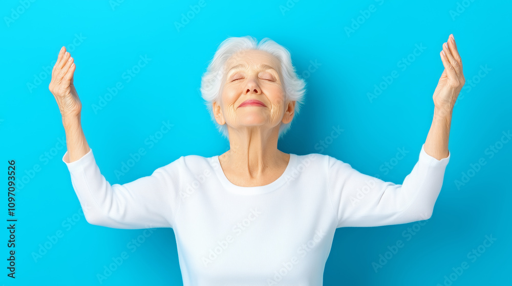 Elderly woman finds peace against a blue backdrop Elderly woman finds peace against a blue backdrop