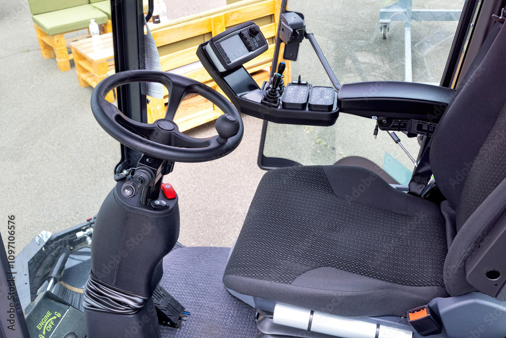 Interior view of modern agricultural tractor showcasing advanced control features and design