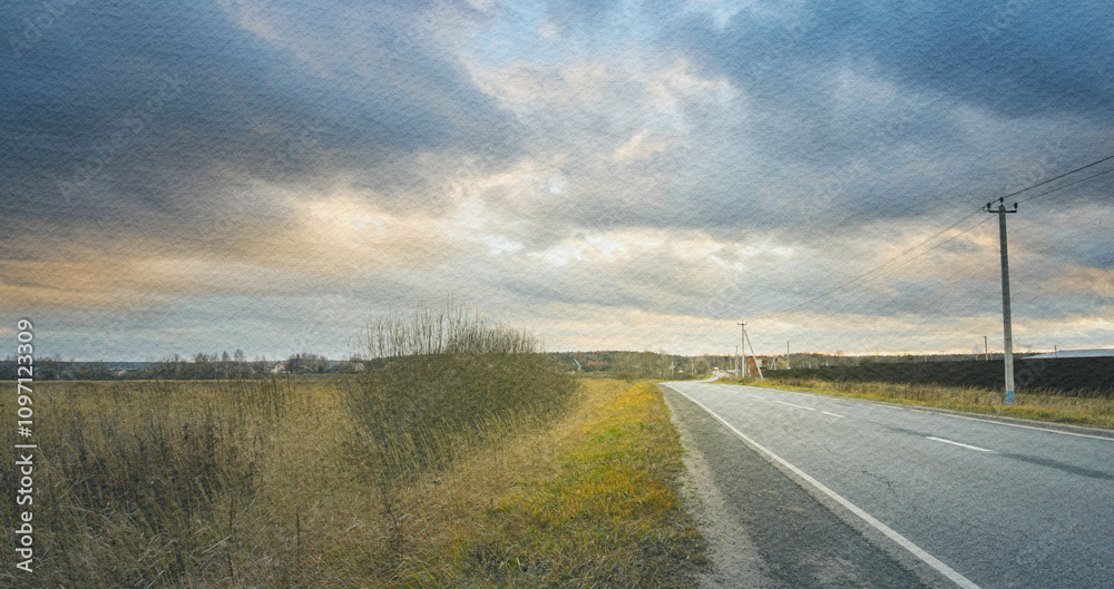 Road with a few trees in the background and a cloudy sky Road with a few trees in the background and a cloudy sky
