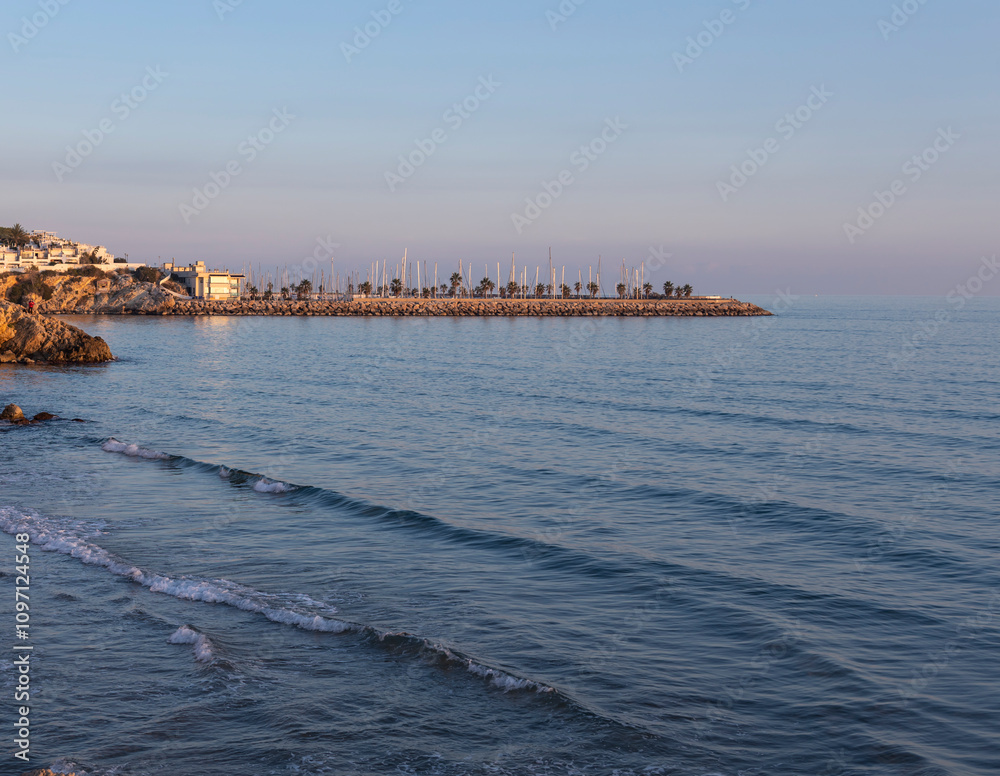 The ocean is calm and the sky is a beautiful shade of blue The ocean is calm and the sky is a beautiful shade of blue