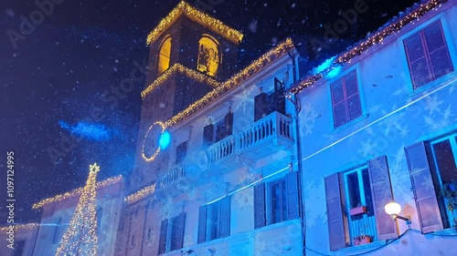 The main square of Mombaroccio medieval village at christmas time in the Marche region during snowfall photo