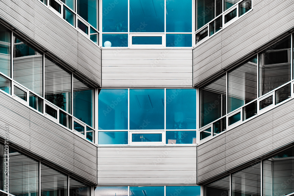 Fototapeta premium Modern Geometric Facade with Glass and Metal Louvers