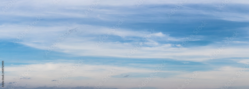 Blue sky covered with white layered clouds in sunny weather Blue sky covered with white layered clouds in sunny weather
