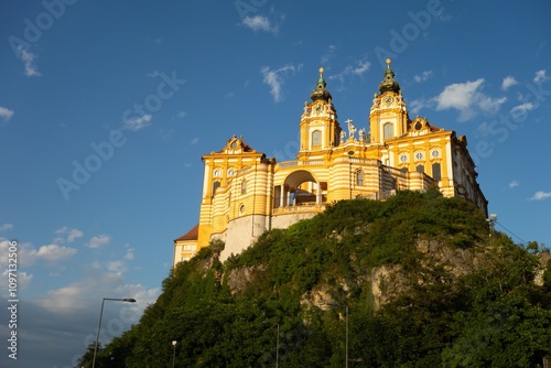 Melk Abbey castle in Austria, huge orange baroque building on rock