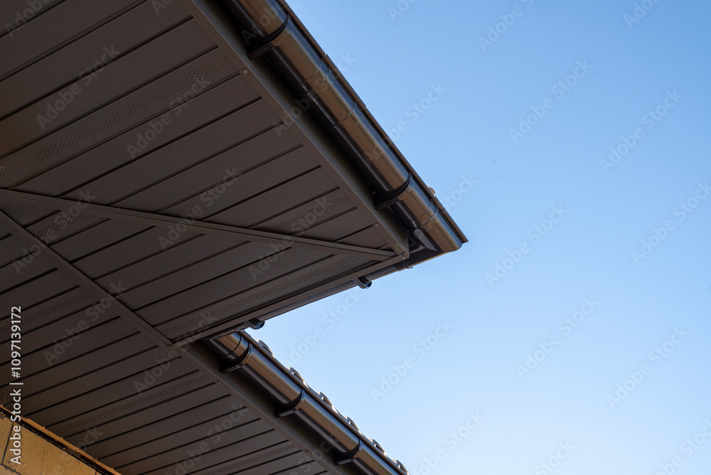 Gray metal soffit on a house with gutter system