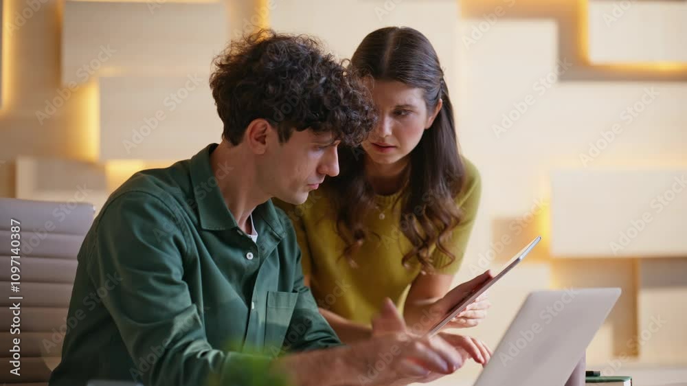 Colleagues cooperating digital tasks at modern office closeup. Two coworkers Colleagues cooperating digital tasks at modern office closeup. Two coworkers