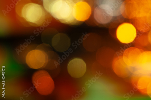 Warm and vibrant bokeh lights create an abstract evening atmosphere using soft focus